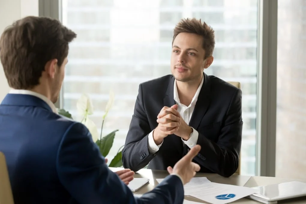 Businessman listening to a business partner during a consultation meeting, discussing a project in an office.